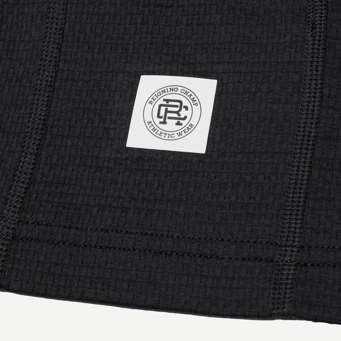 Reigning Champ Solotex Mesh Tiebreak Short 7-inch in black, featuring breathable mesh fabric and athletic fit.