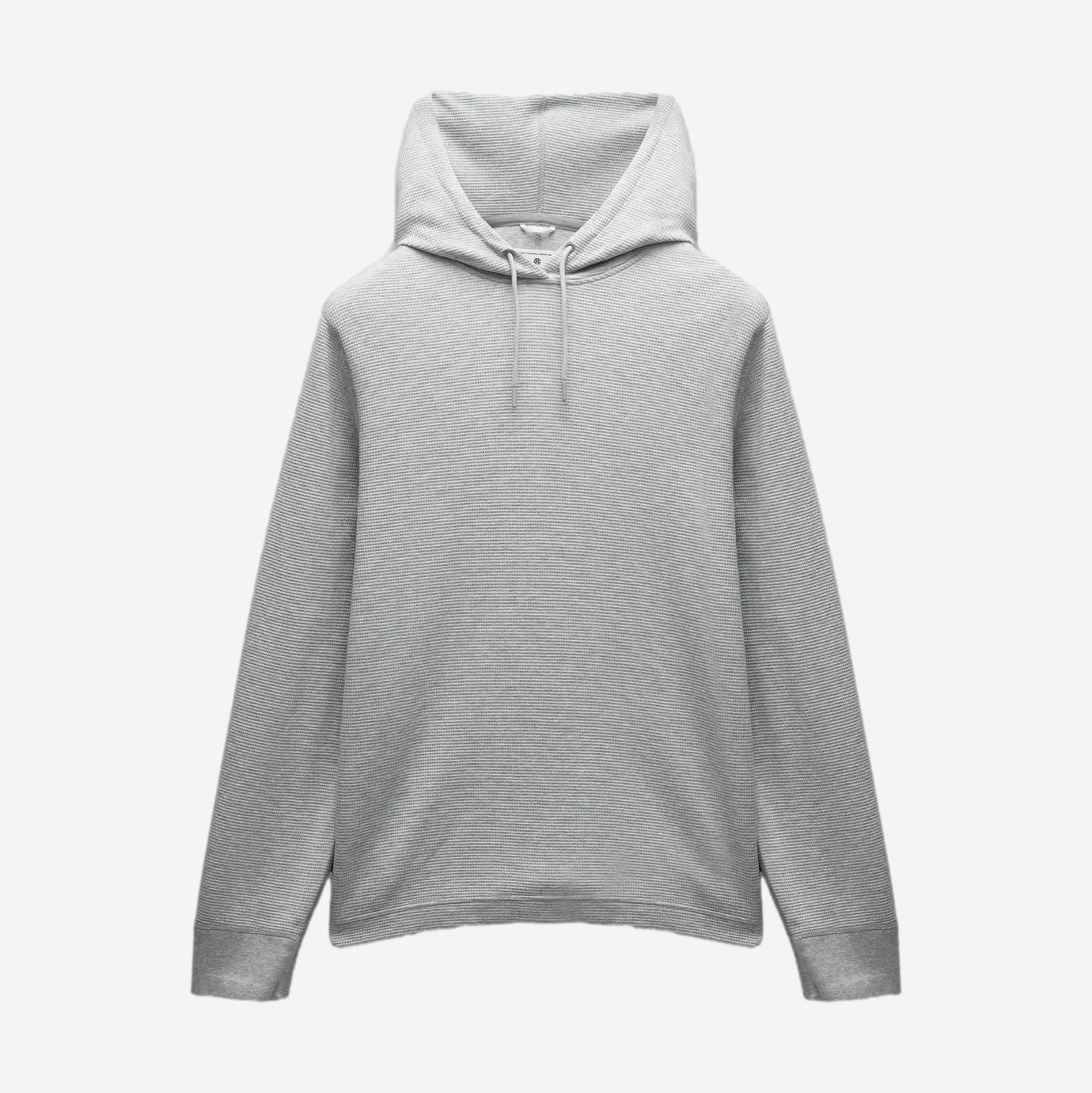 Reigning Champ lightweight waffle hoodie in heather grey, showing the soft fabric and classic sweatshirt design.