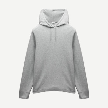 Reigning Champ lightweight waffle hoodie in heather grey, showing the soft fabric and classic sweatshirt design.