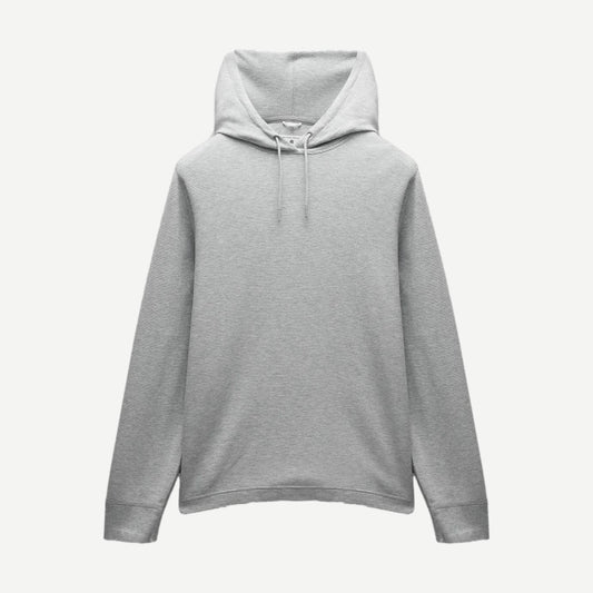 Reigning Champ lightweight waffle hoodie in heather grey, showing the soft fabric and classic sweatshirt design.