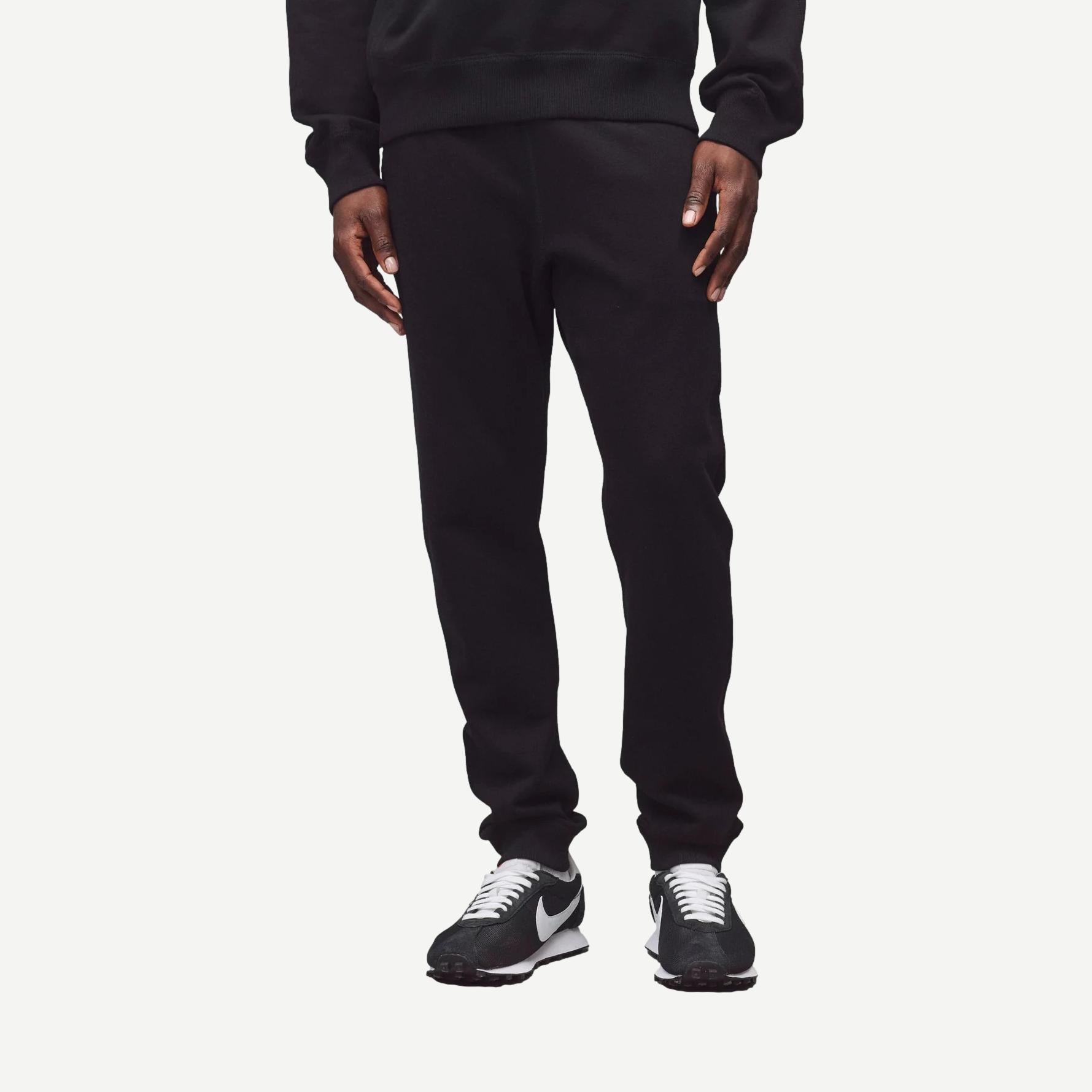 Black Reigning Champ midweight Terry Slim Sweatpant laid flat showing waistband and relaxed fit, ideal for casual wear.