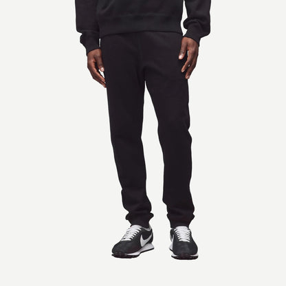 Black Reigning Champ midweight Terry Slim Sweatpant laid flat showing waistband and relaxed fit, ideal for casual wear.