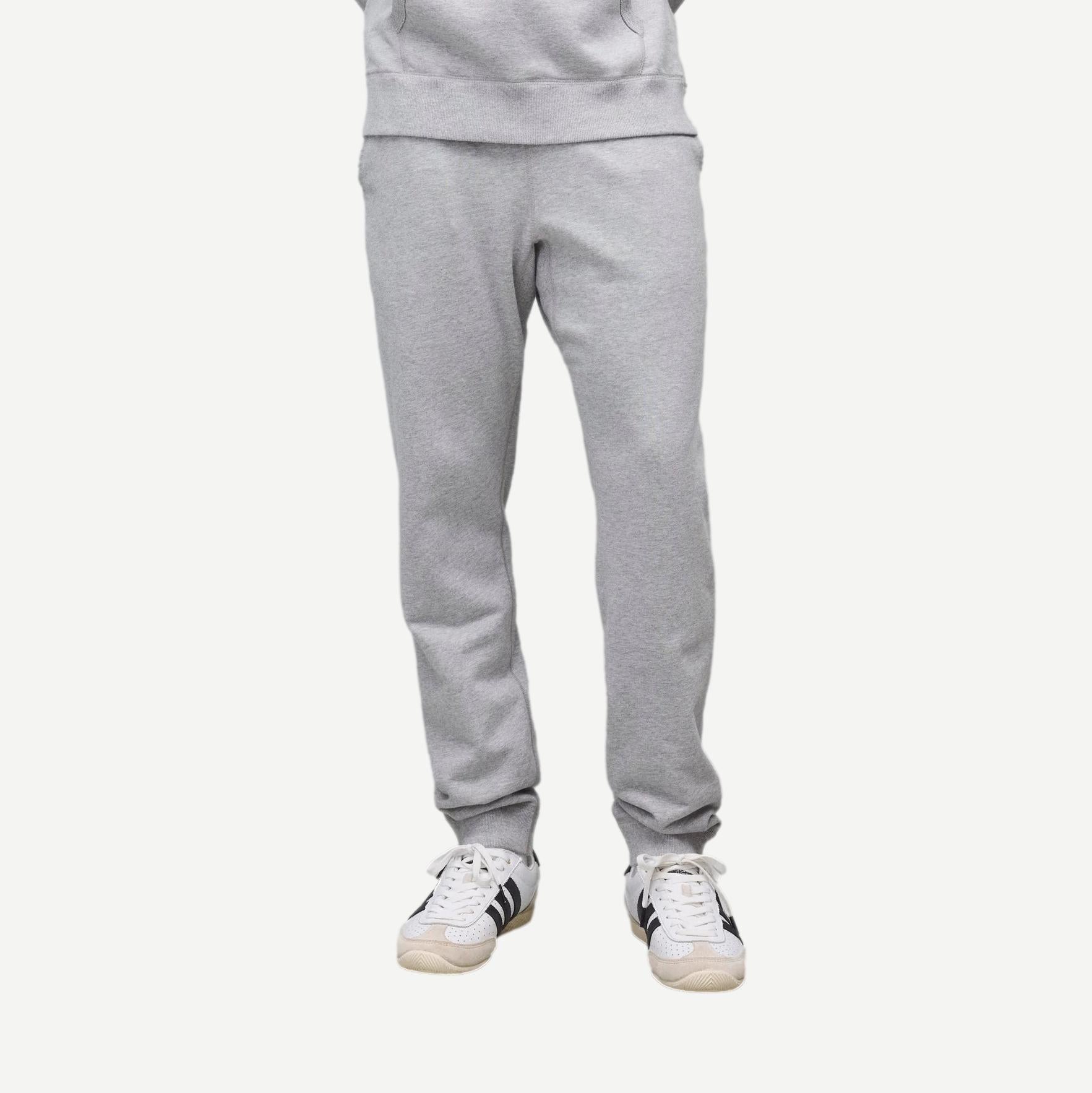 Reigning Champ Heather Grey midweight terry slim sweatpants displayed on a model, showcasing soft fabric and modern fit.