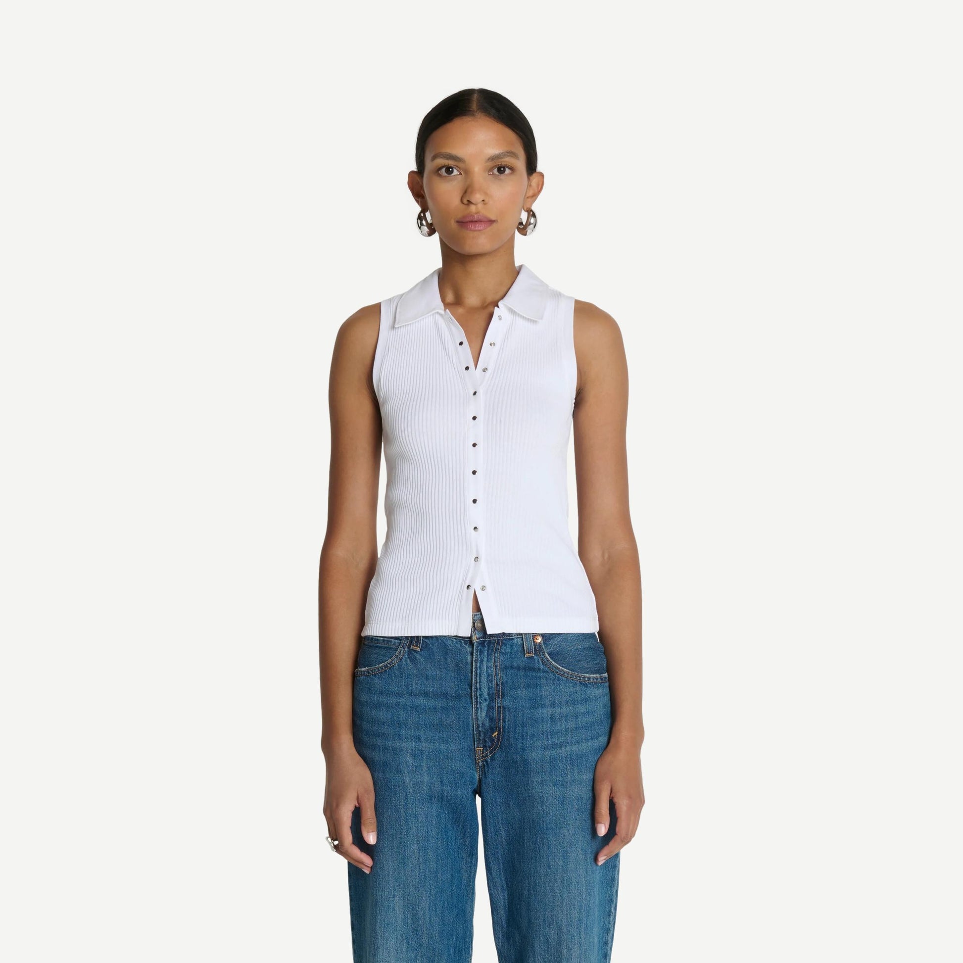 White Nation LTD Jaylin Polo Top displayed on a hanger, showcasing its classic collar and clean, minimalist design.