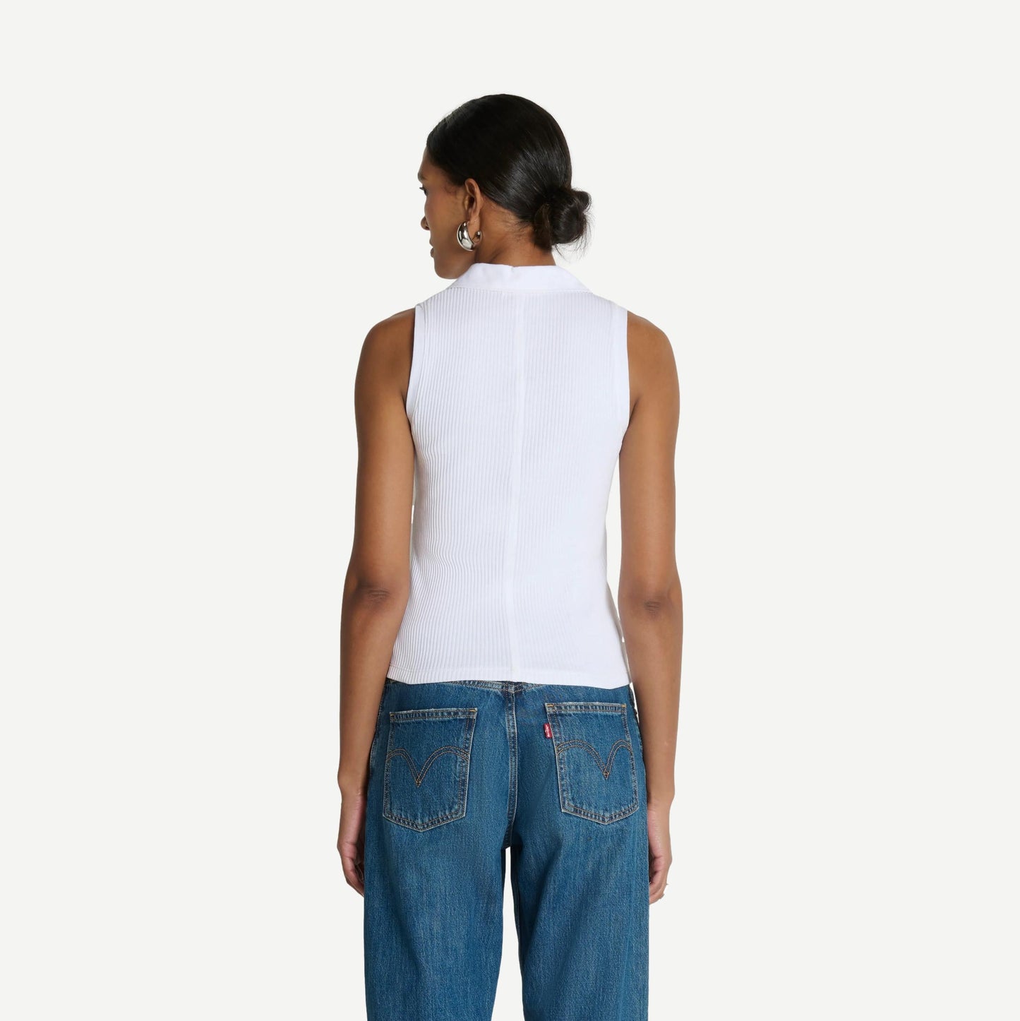 White Jaylin Polo Top by Nation LTD, close-up of the classic collared polo shirt with short sleeves and clean design.