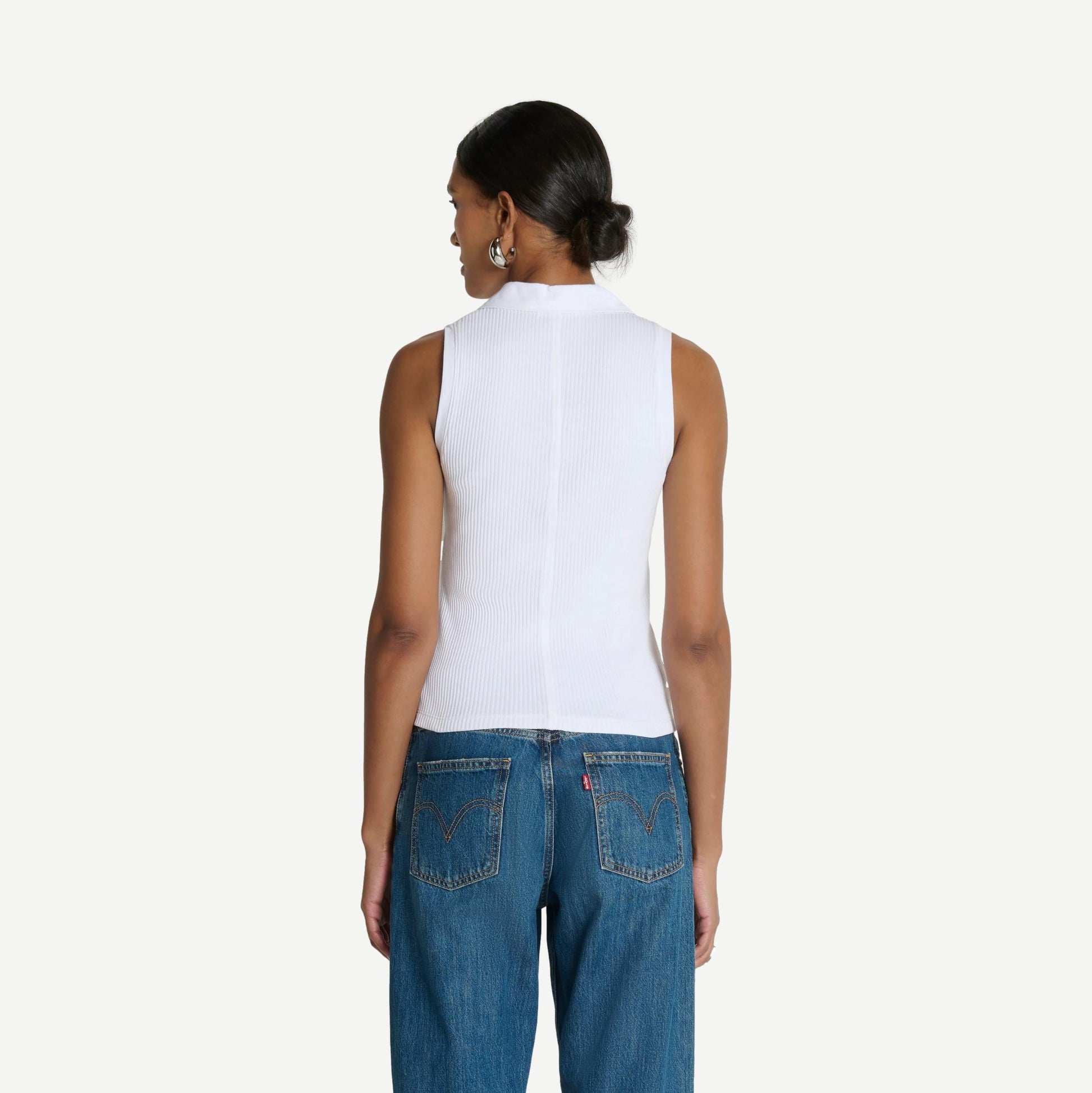 White Jaylin Polo Top by Nation LTD, close-up of the classic collared polo shirt with short sleeves and clean design.