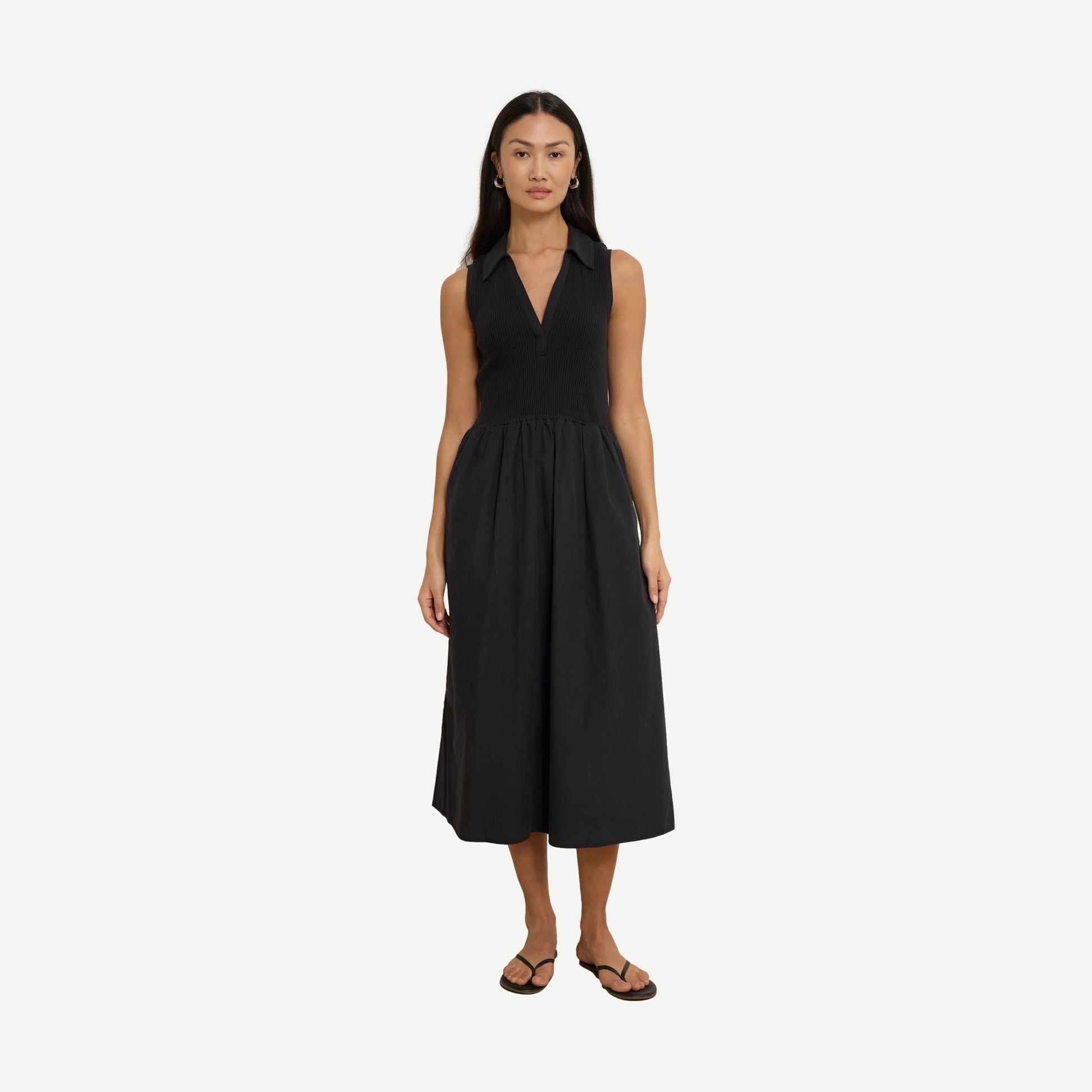 Jessica Midi Dress by Nation LTD in jet black, featuring a sleek, fitted silhouette and elegant midi length, worn by a model.