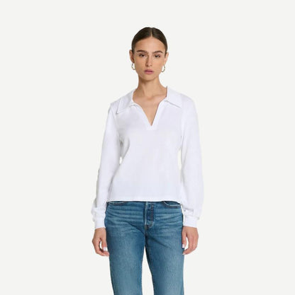 Kimberley Polo Tee by Nation LTD in optic white, showcasing a classic fit with a collar and short sleeves on a model.