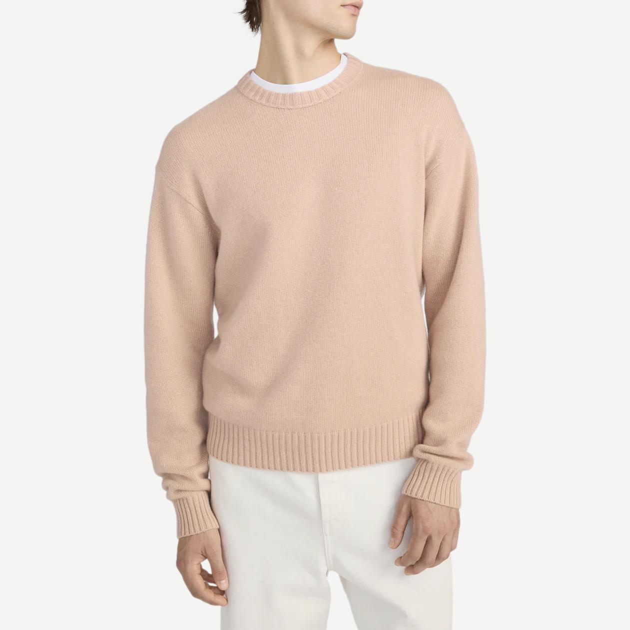 Pale peach cashmere crewneck sweater by Frame Denim, showcasing soft texture and classic design.