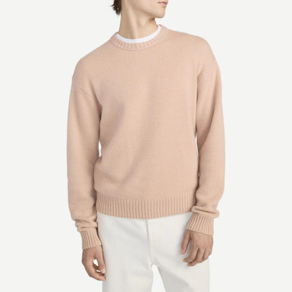 Pale peach cashmere crewneck sweater by Frame Denim, showcasing soft texture and classic design.