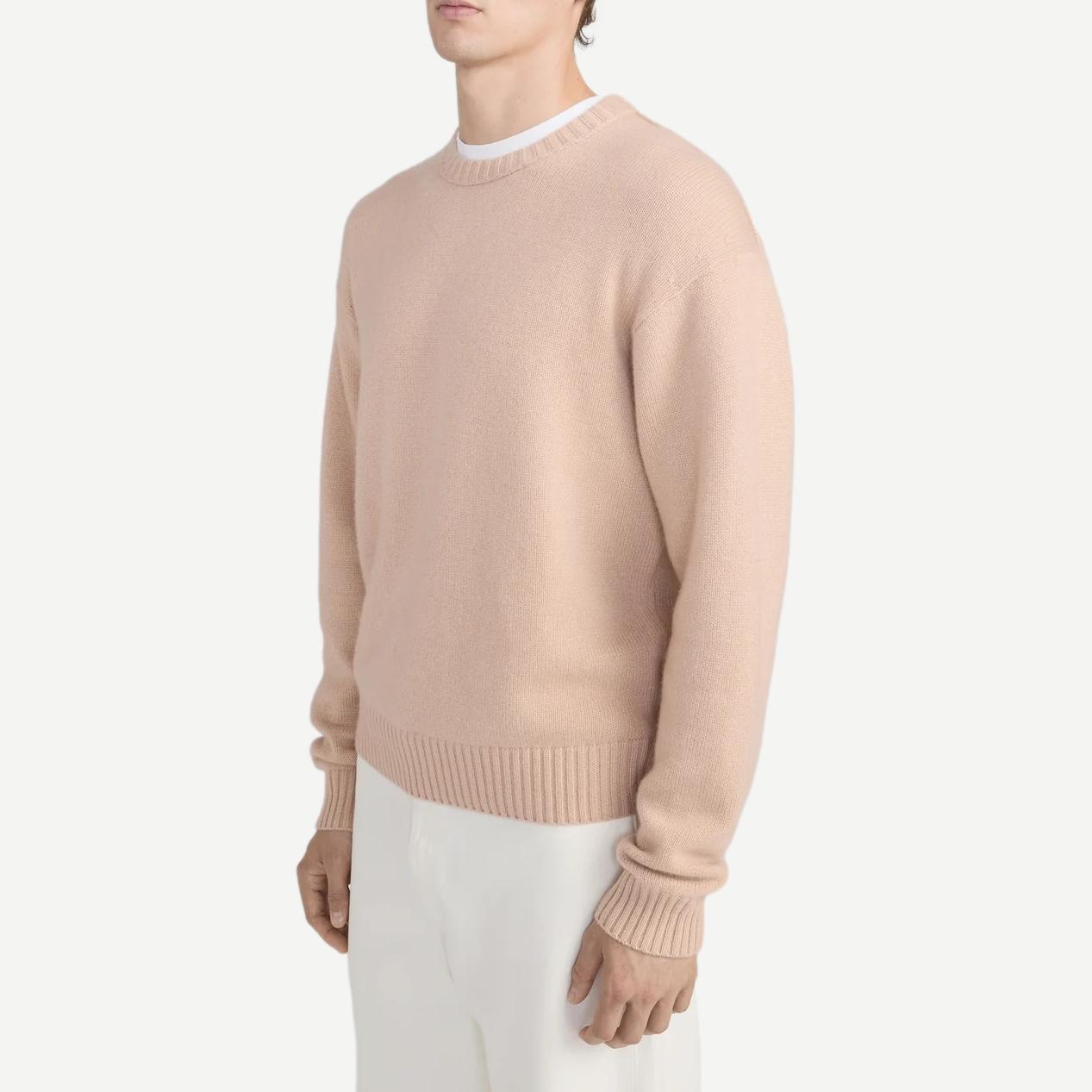 Pale peach cashmere crewneck sweater by Frame Denim, featuring a soft texture and classic fit.