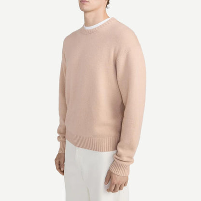 Pale peach cashmere crewneck sweater by Frame Denim, featuring a soft texture and classic fit.