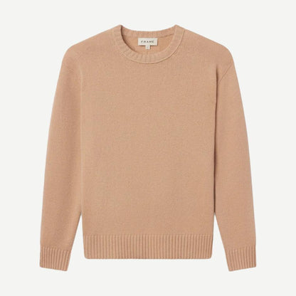 Pale peach cashmere crewneck sweater by Frame Denim, featuring a classic fit and soft texture displayed on a neutral background.