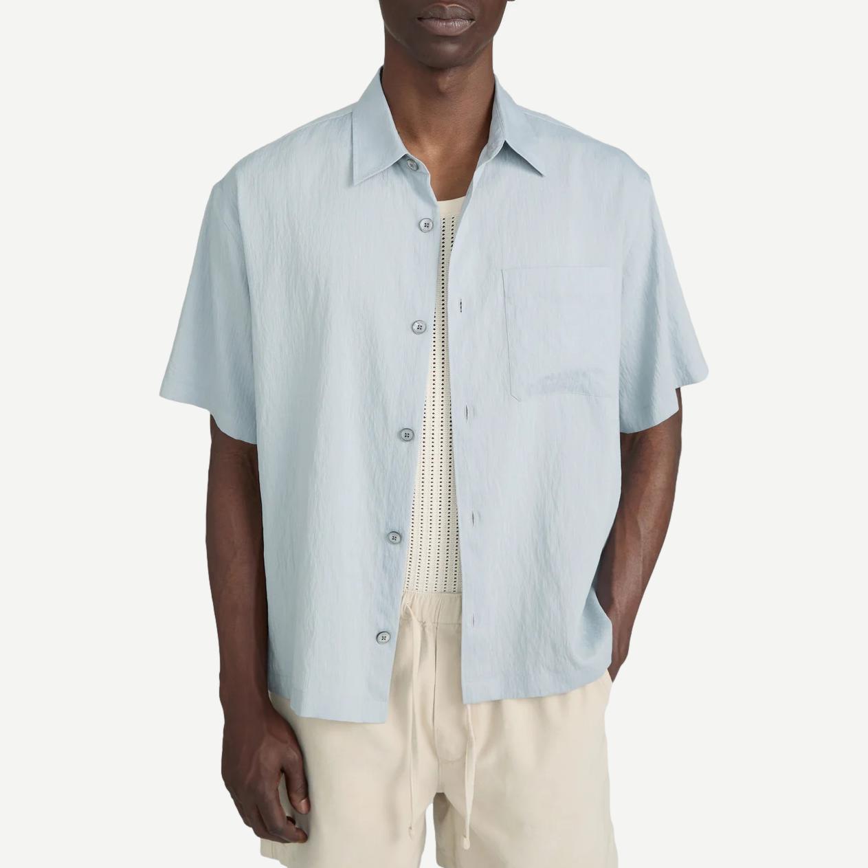 Blue grey striped lightweight short-sleeve button-up shirt by Frame Denim, styled on a hanger.