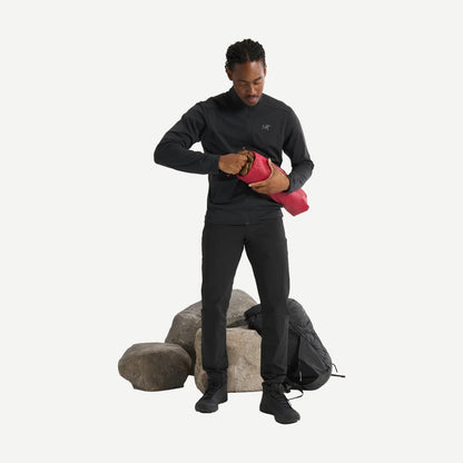 Black Arcteryx Kyanite lightweight jacket displayed on a full-body model, showcasing its sleek design and fitted style.