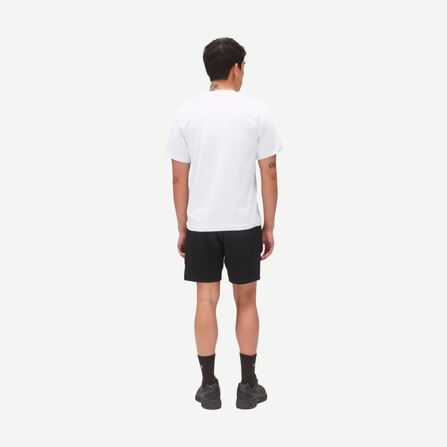 Reigning Champ black Solotex Mesh Tiebreak 7-inch shorts displayed on a model, featuring lightweight breathable fabric and athletic fit.