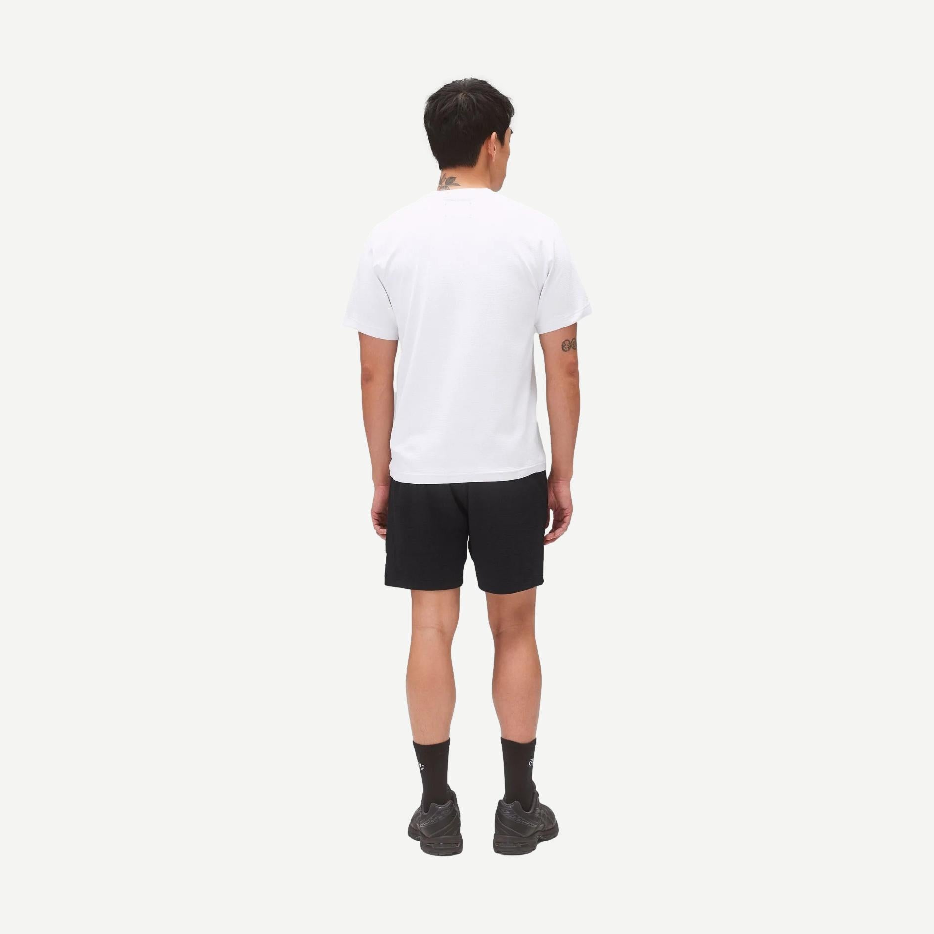 Reigning Champ black Solotex Mesh Tiebreak 7-inch shorts displayed on a model, featuring lightweight breathable fabric and athletic fit.