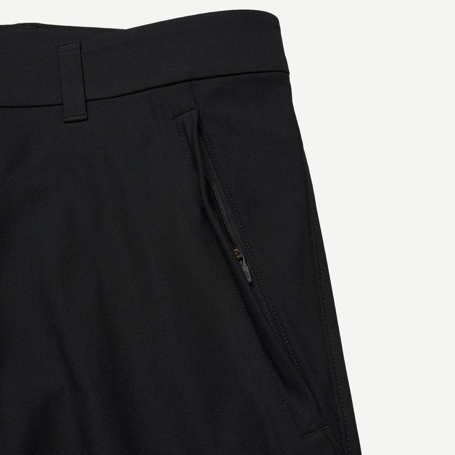Black Stretch Warp Knit Coach's Slim Pant by Reigning Champ, showing the sleek, fitted design and smooth fabric details.