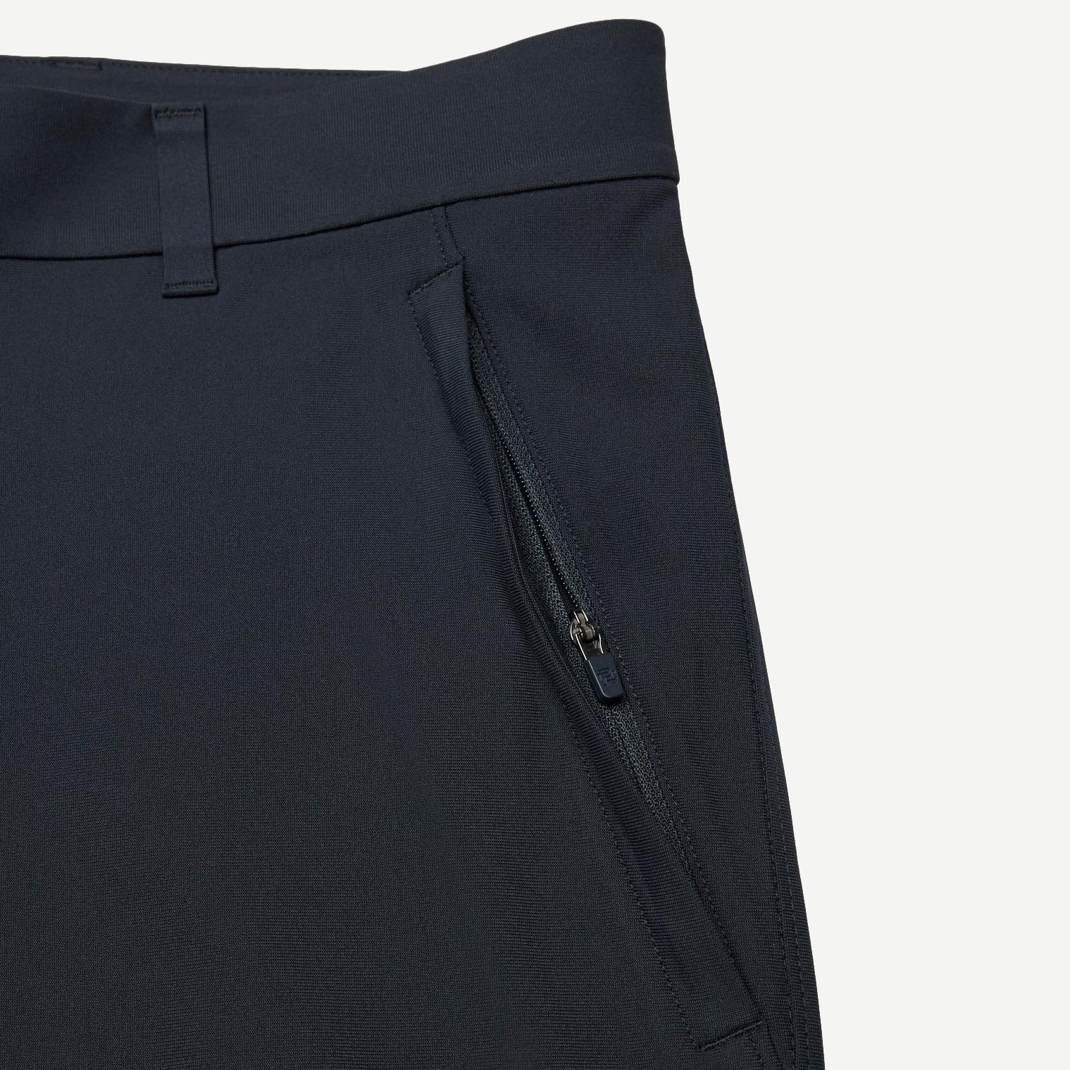 Reigning Champ navy Stretch Warp Knit Coach's Slim Pants displayed flat with waistband and tapered leg details.