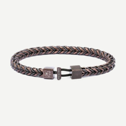 Pig & Hen PH Catena Foxtail bracelet in slate grey and bronze with a textured, woven design on a natural fiber band.