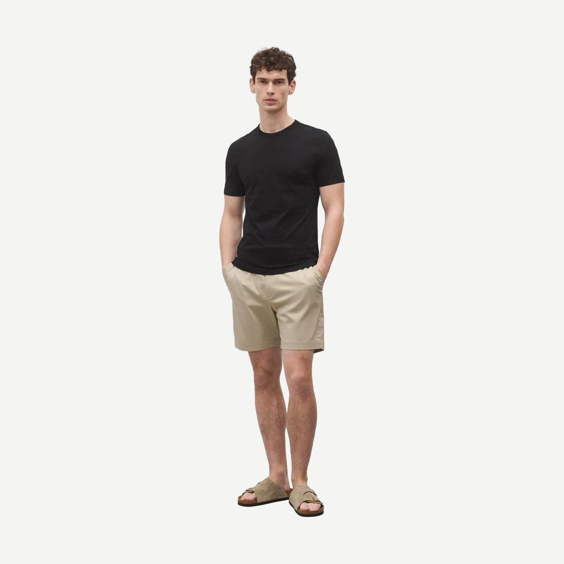 Black Reigning Champ lightweight jersey slim T-shirt laid flat, showcasing its classic fit and soft fabric.