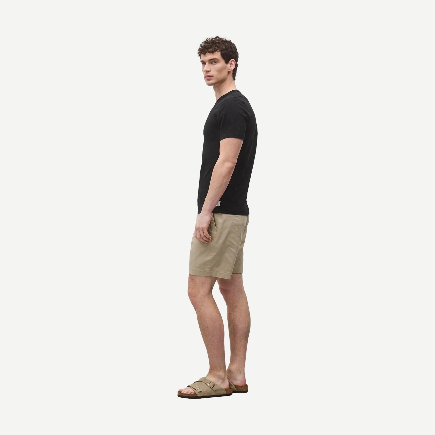 Black Reigning Champ lightweight jersey slim T-shirt displayed flat, showing its soft fabric and simple design.