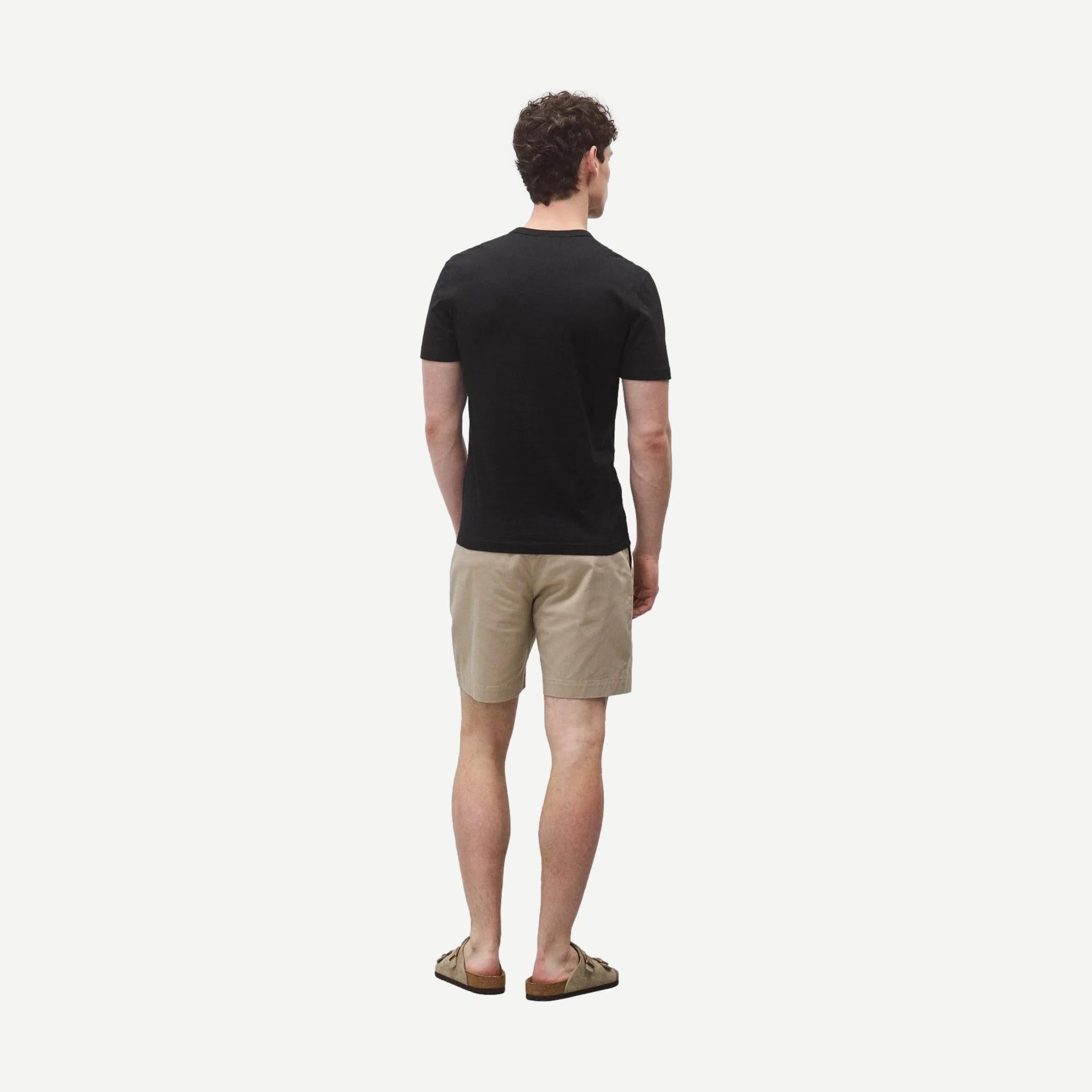Black lightweight jersey slim-fit T-shirt from Reigning Champ displayed on a hanger.