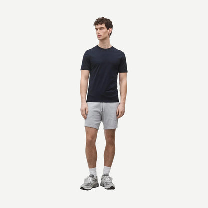 Reigning Champ navy lightweight jersey slim fit T-shirt displayed on a hanger, showcasing soft fabric and modern design.