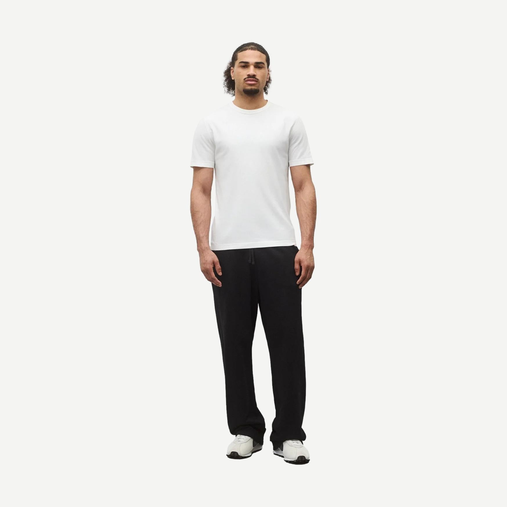 Reigning Champ lightweight white jersey slim T-shirt displayed on a hanger with a close-up view of fabric texture.