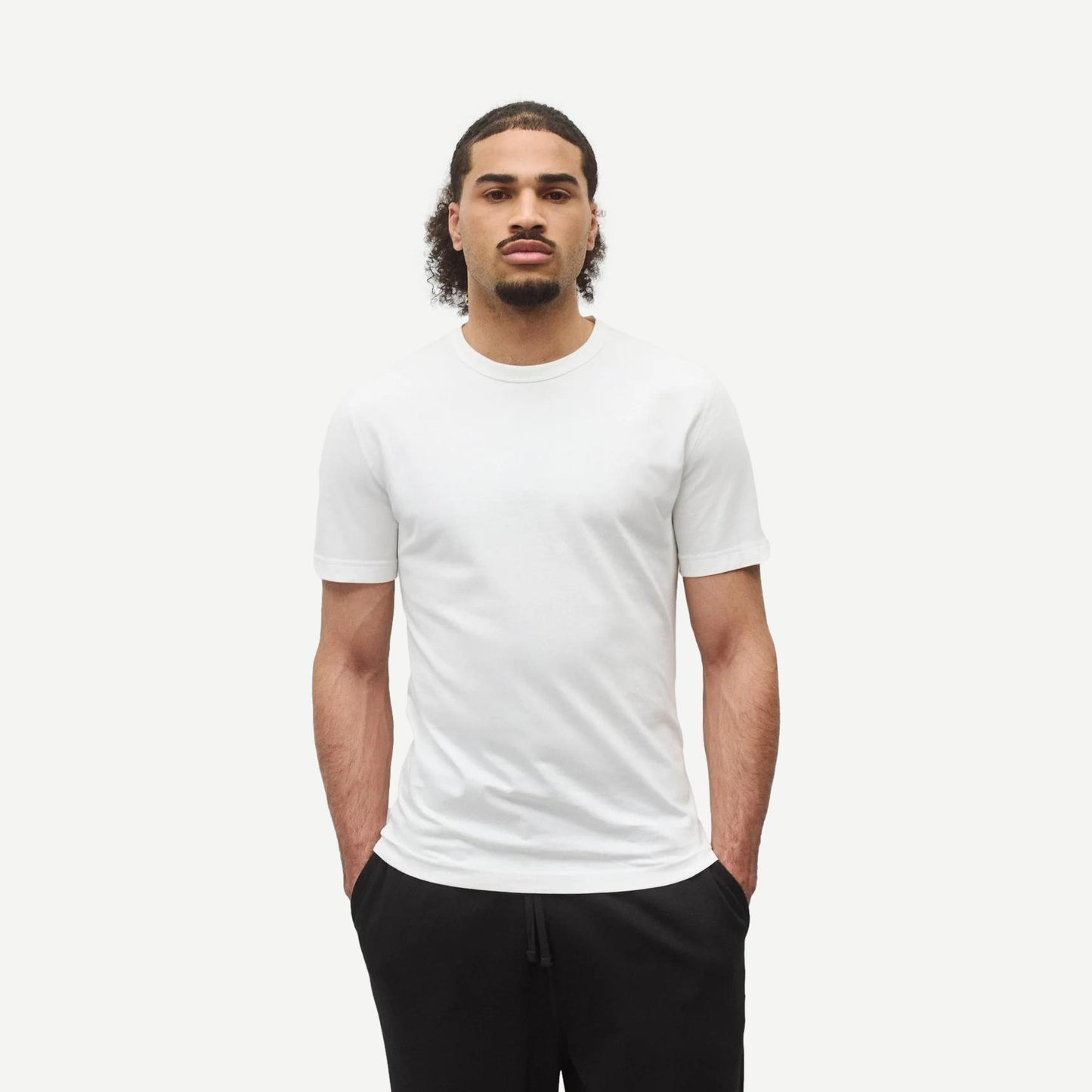 Reigning Champ lightweight white jersey slim T-shirt displayed flat, showing clean design and soft fabric texture.
