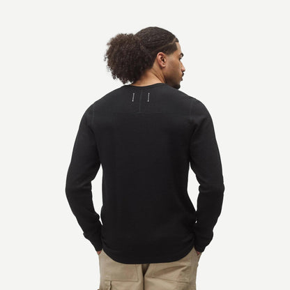 Reigning Champ lightweight waffle henley shirt in black, showing the textured fabric, henley collar, and long sleeves.