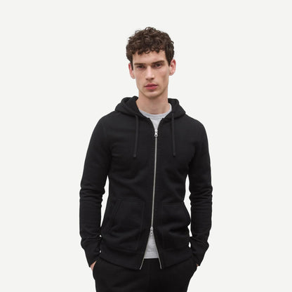 Reigning Champ black midweight terry slim zip hoodie, sweatshirt style, shown on model with front zipper and hood.