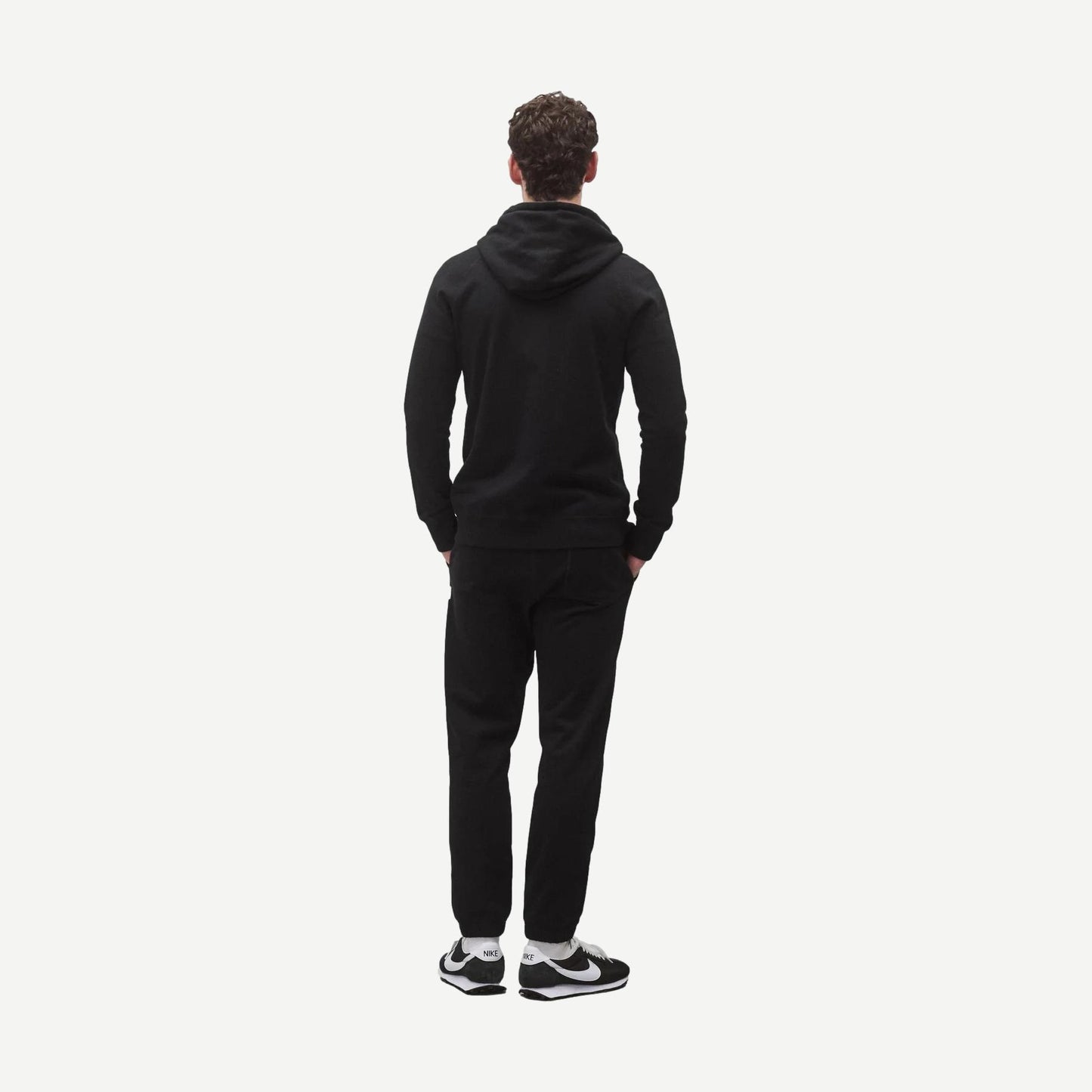 Black Reigning Champ midweight terry slim zip hoodie, shown on model, featuring a full front zipper and casual sweatshirt style.