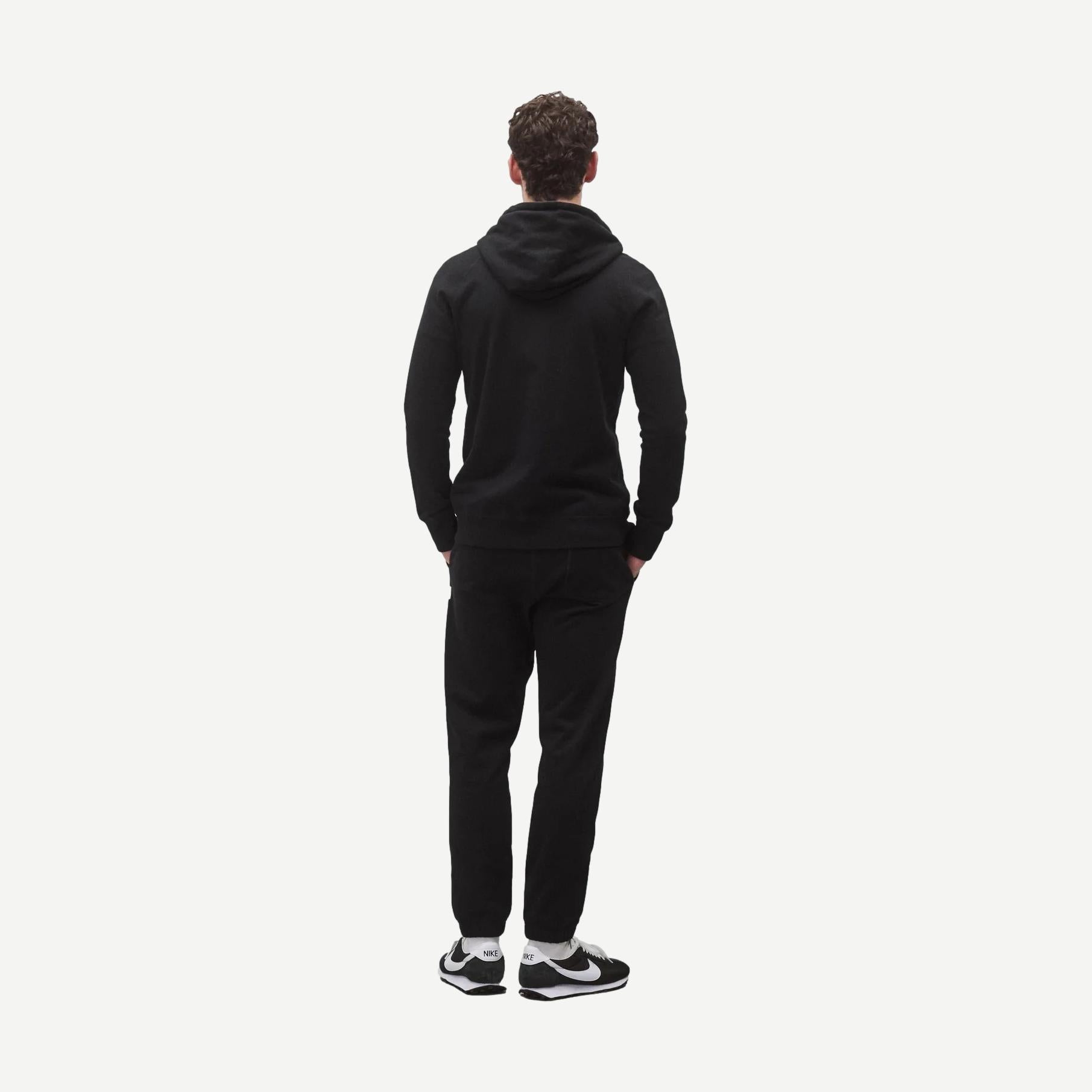 Black Reigning Champ midweight terry slim zip hoodie, shown on model, featuring a full front zipper and casual sweatshirt style.