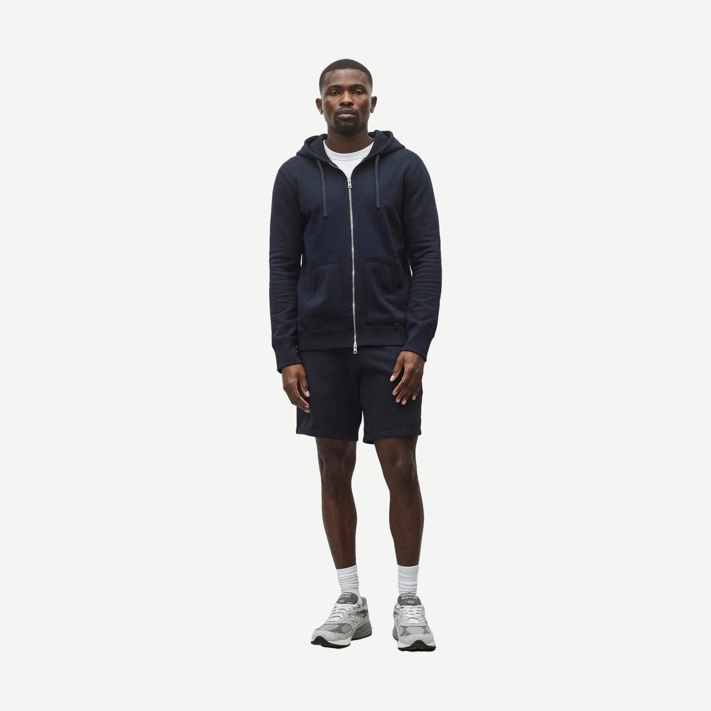 Navy Reigning Champ midweight terry slim zip hoodie with front zipper and ribbed cuffs, displayed on a plain background.