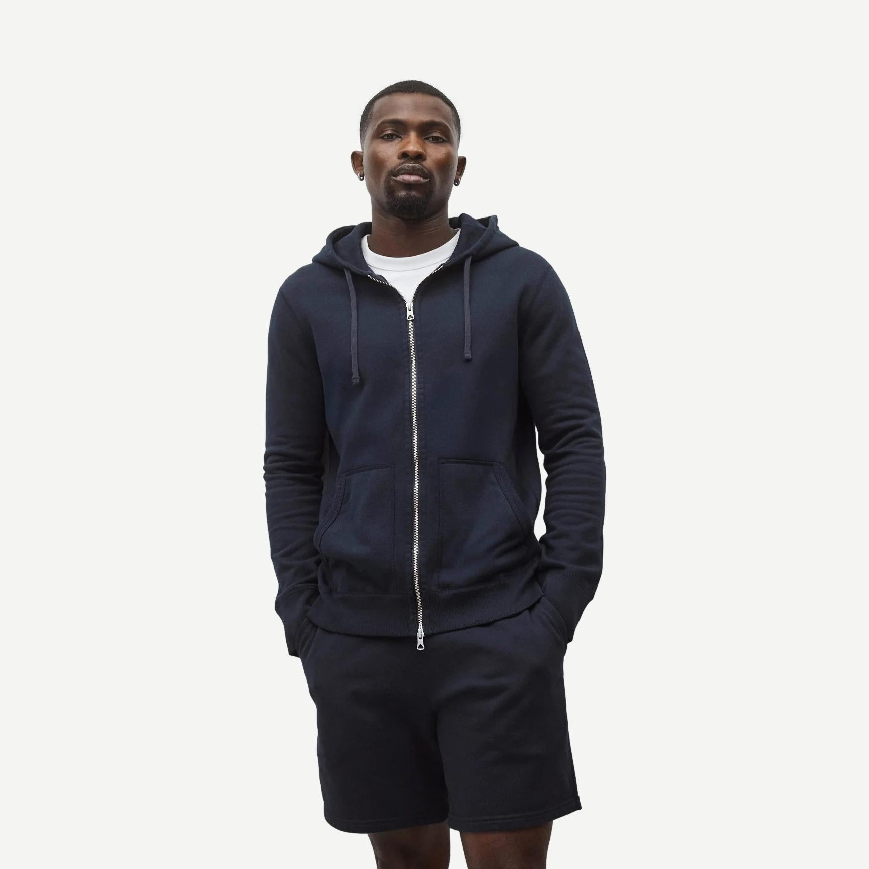 Reigning Champ navy midweight terry slim zip hoodie, front view showing full zipper and hoodie details.