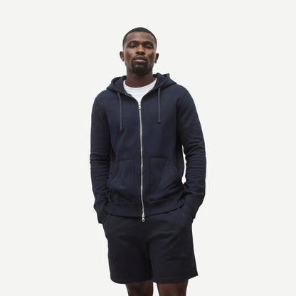 Reigning Champ navy midweight terry slim zip hoodie, front view showing full zipper and hoodie details.