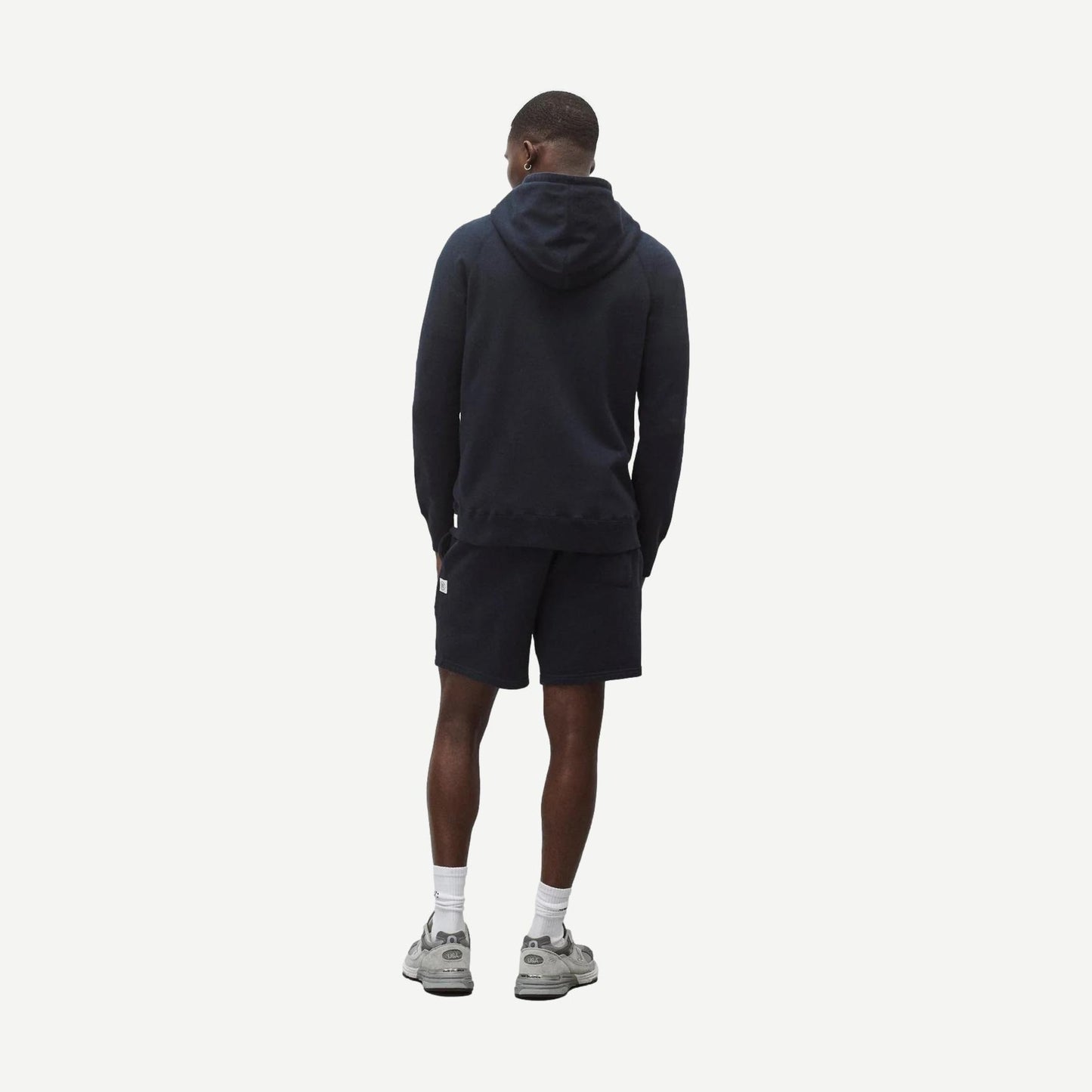 Reigning Champ navy midweight terry slim zip hoodie, casual sweatshirt with front zipper and hood, shown on a model.