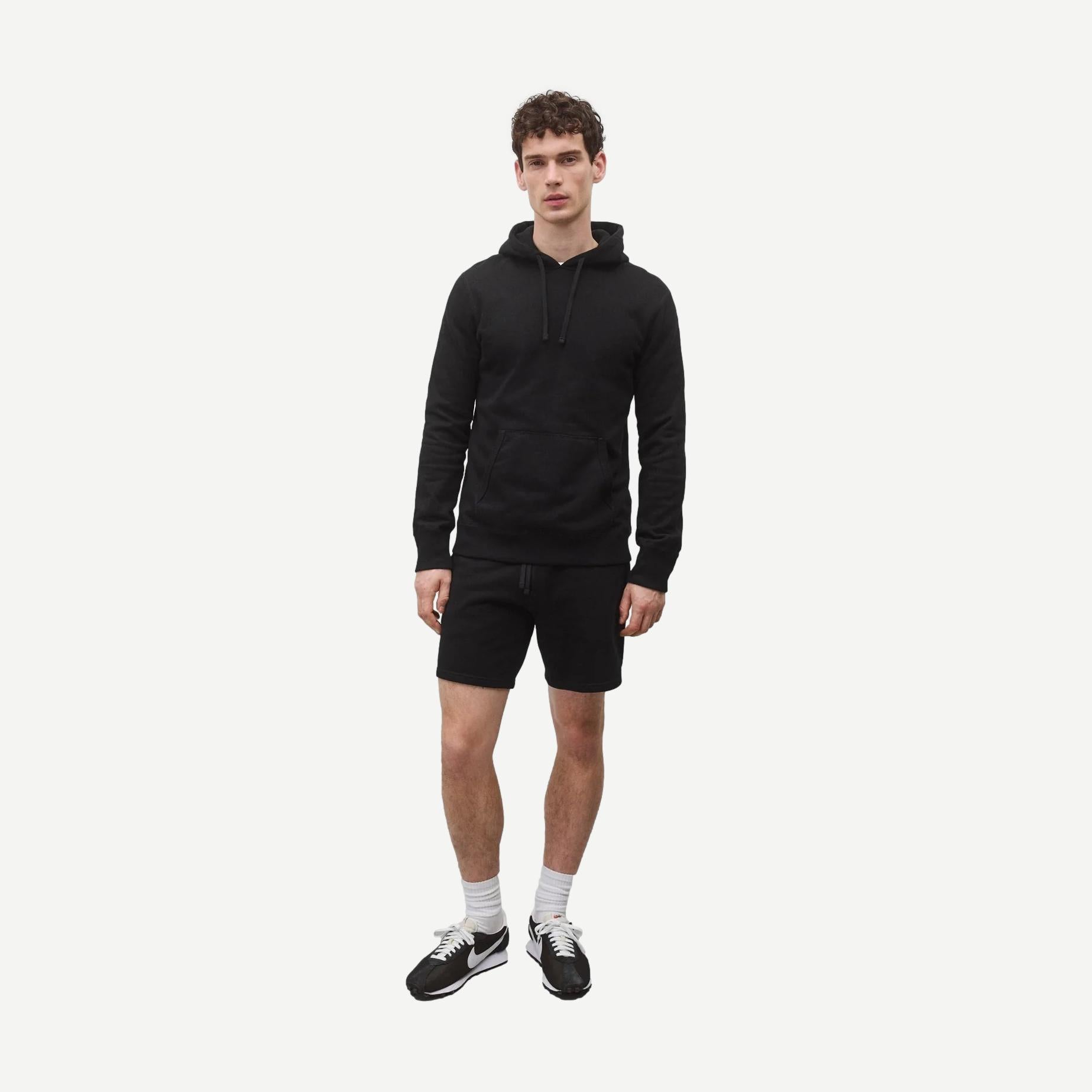 Reigning Champ black midweight terry slim hoodie, sweatshirts style, showing the front view with a relaxed fit and subtle branding.