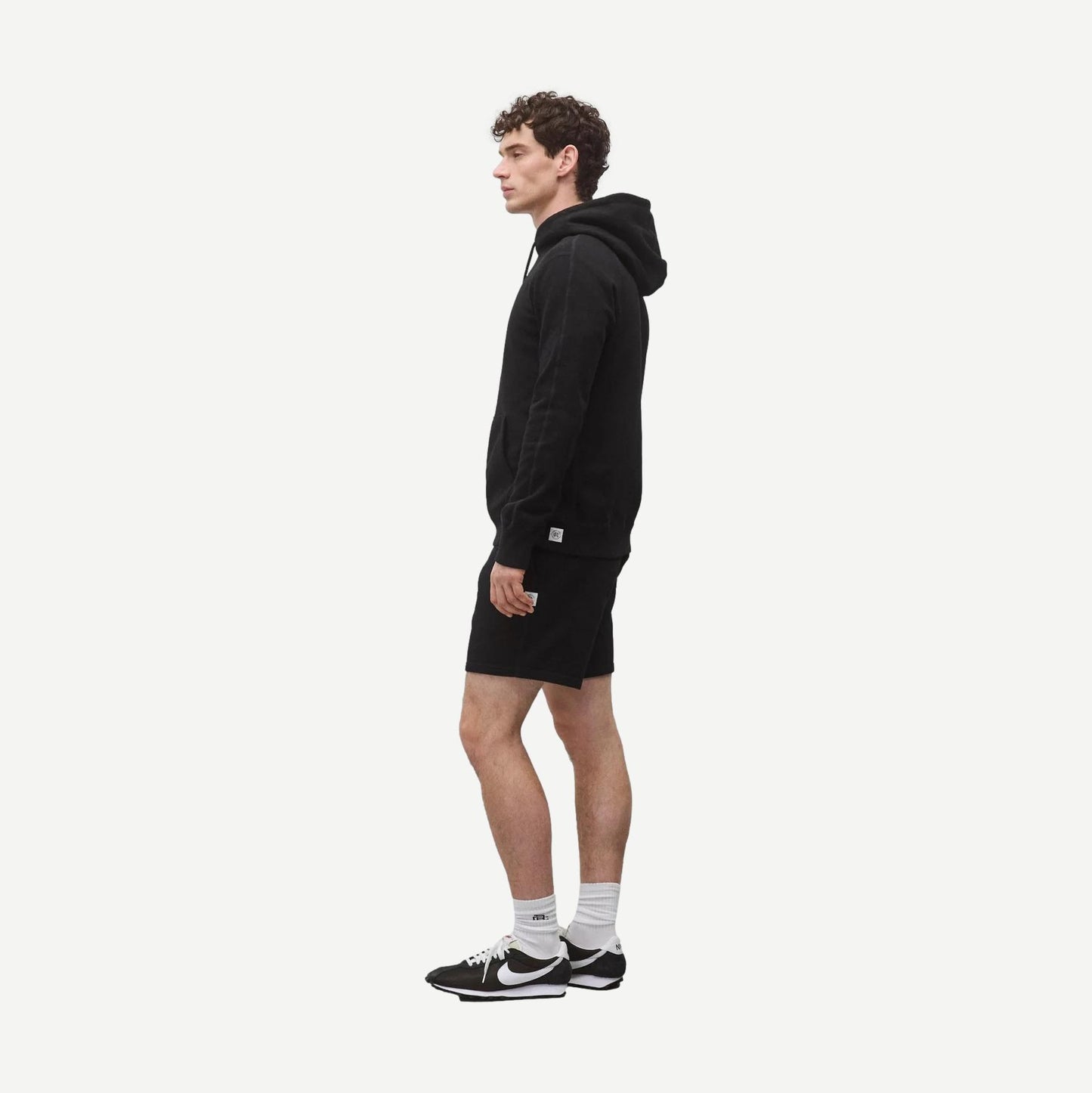 Black Reigning Champ Midweight Terry Slim Hoodie sweatshirt showing the fitted design and soft fabric texture.