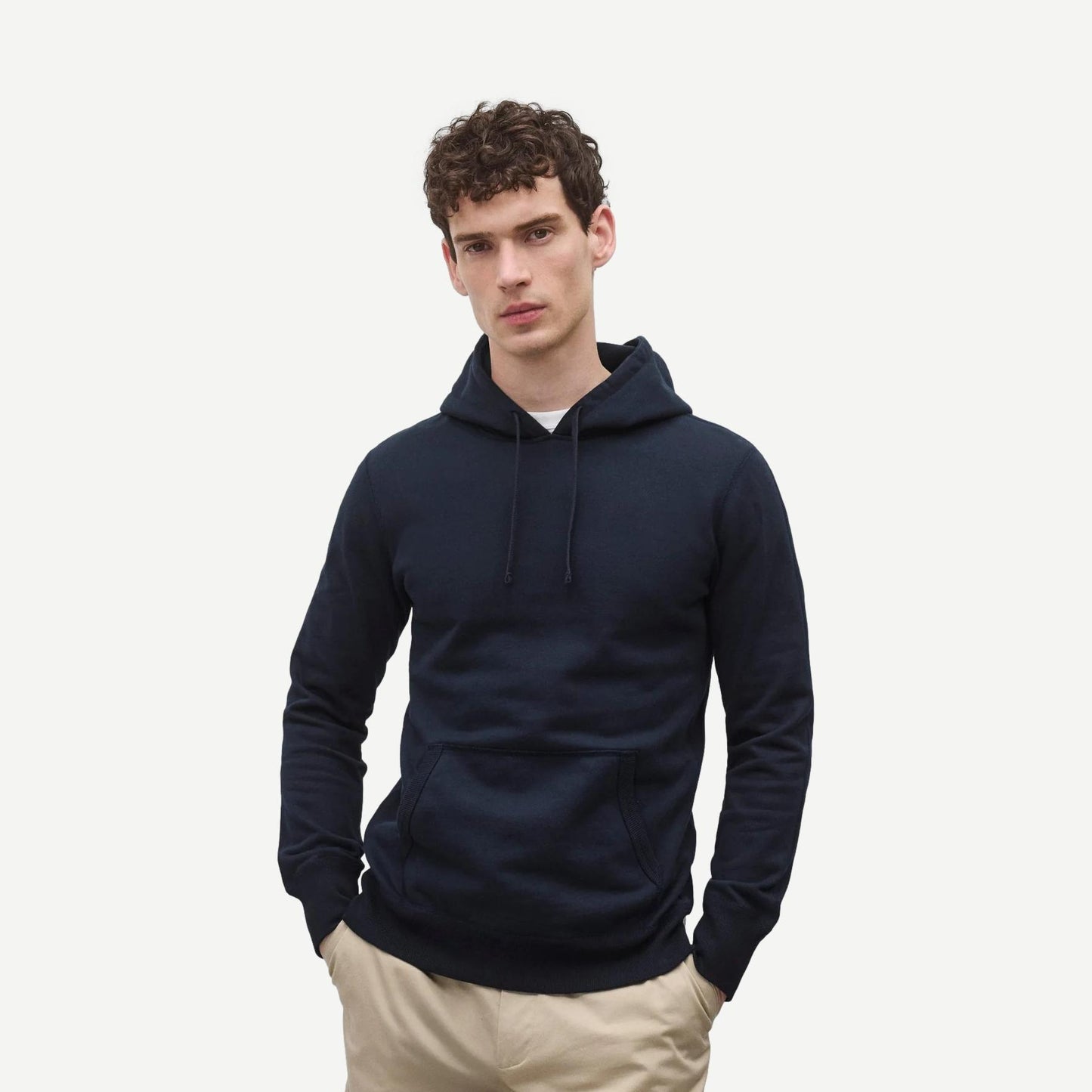 Reigning Champ navy midweight Terry slim hoodie sweatshirt, shown on model with a relaxed fit and ribbed cuffs.