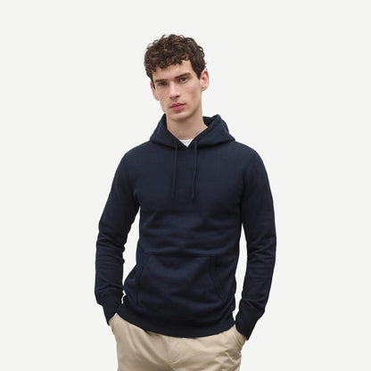 Reigning Champ navy midweight Terry slim hoodie sweatshirt, shown on model with a relaxed fit and ribbed cuffs.