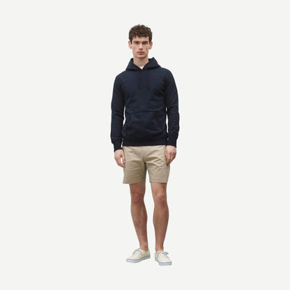 Reigning Champ navy midweight terry slim hoodie, front view showing soft fabric and classic hoodie design.