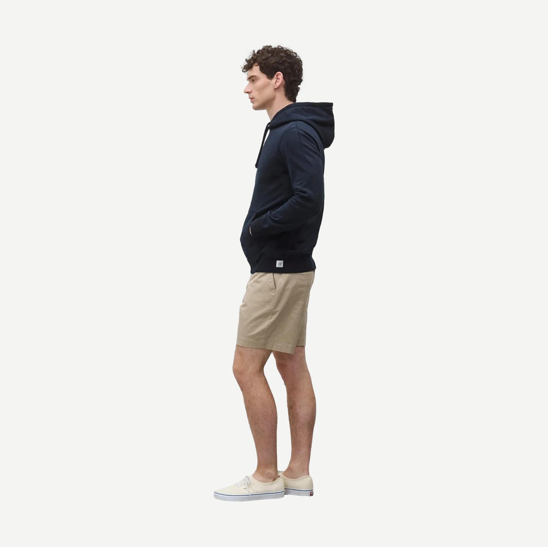 Reigning Champ navy midweight terry slim hoodie, showing front view with hood and long sleeves.