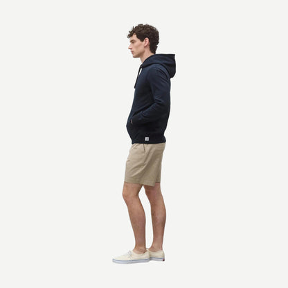 Reigning Champ navy midweight terry slim hoodie, showing front view with hood and long sleeves.