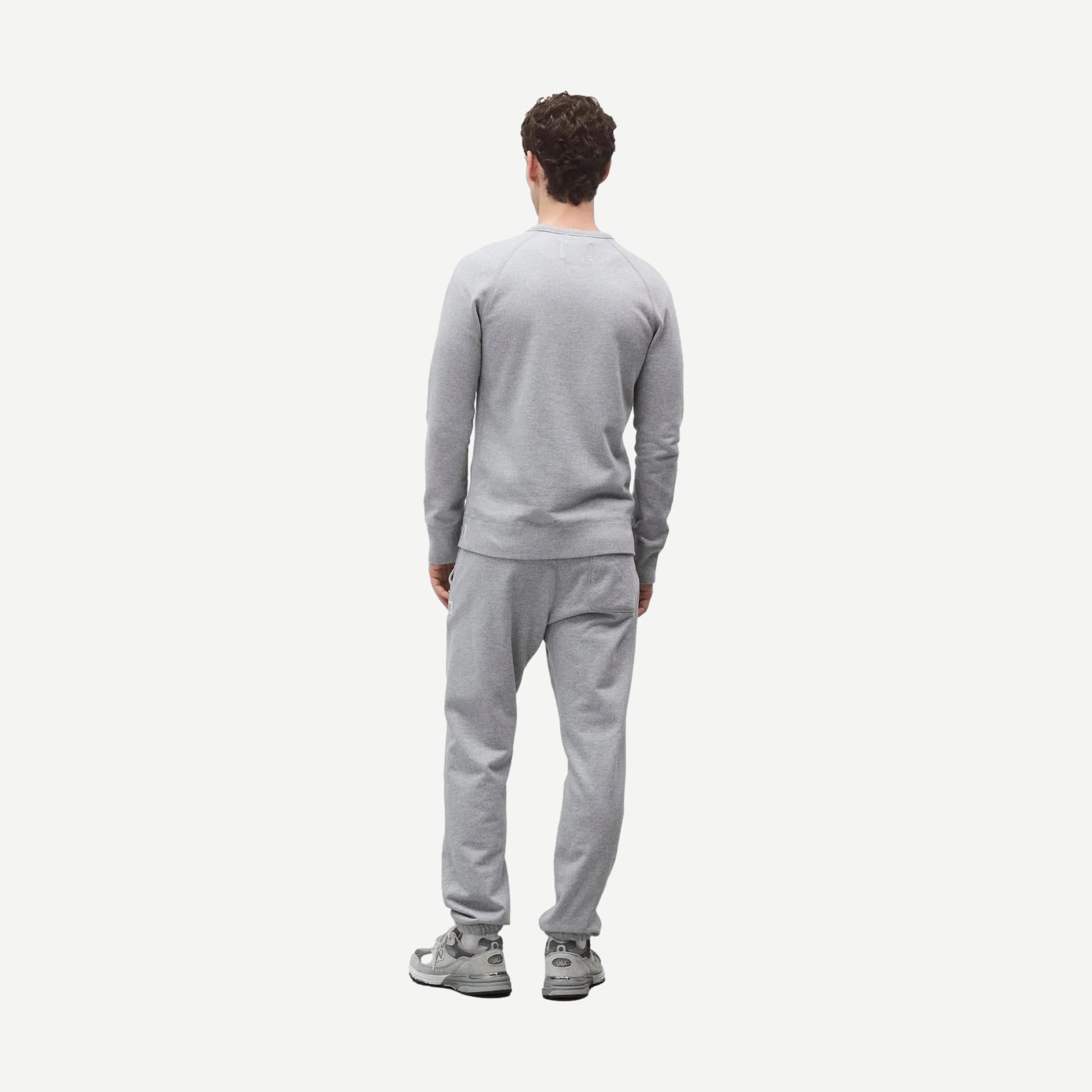 Reigning Champ midweight terry slim crewneck sweatshirt in heather grey, showing the classic crew neckline and soft fabric texture.
