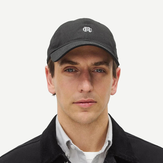 Reigning Champ black New Era 9Twenty mini monogram cap, adjustable hat with curved brim and embroidered logo detail.