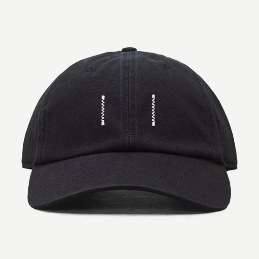 Reigning Champ washed black cotton chino low pro strapback cap, front view showing adjustable strap and classic hat design