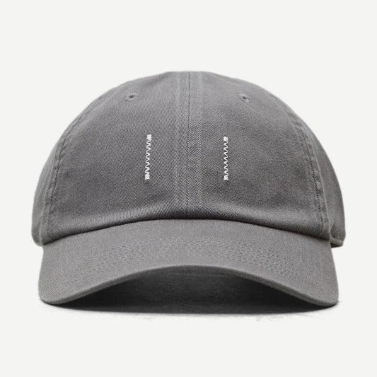 Reigning Champ washed grey cotton chino low pro strapback cap with curved brim and adjustable strap, close-up view.
