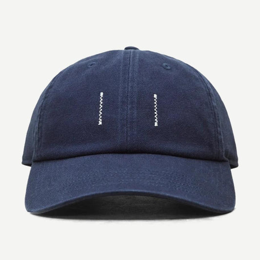 Reigning Champ washed navy cotton chino low pro strapback cap with a curved brim and adjustable strap.